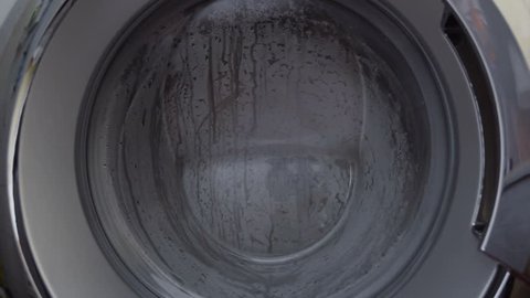 Washing machine door with rotating garments inside
