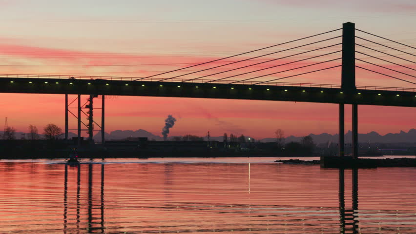 Rail Commuters at Sunrise, Vancouver 4K UHD. Morning Commuters cross a bridge at sunrise. Vancouver, Fraser River 4K UHD
