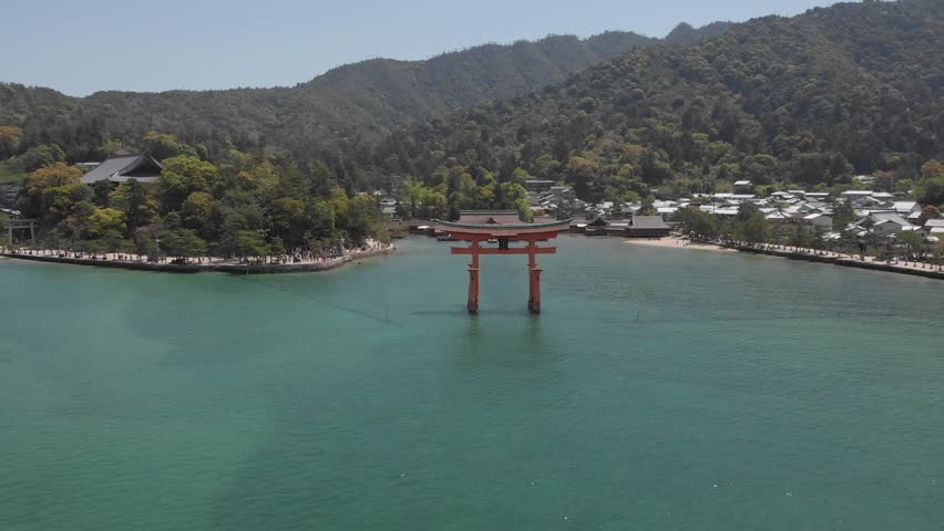 Aerial Drone dramatically approaching from Itsukushima Shrine at Miyajima, Hiroshima, Japan.
