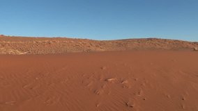 HD high quality video of red sand dunes and barchans in famous endless sand sea area of Sossusvlei Namib Desert on sunny early morning in Namib-Naulkuft Park in Namibia, southern Africa