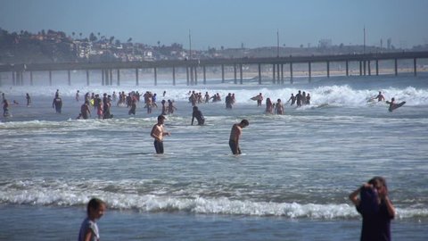 Los Angeles, California / USA - July 7th, 2016: Crowded Beach of bathers, tourists, and surfers. 