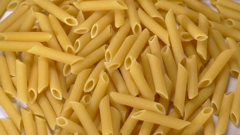 Top view of pasta penne with rotating motion as food background