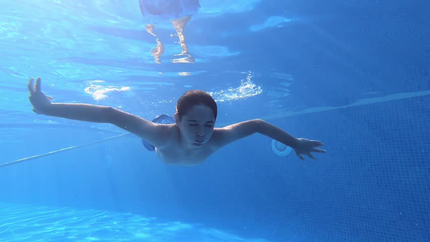 Kid Swimming Underwater on the Breath hold, Boy Diving in the Pool, -LONG- 
Slow-motion, Summer, Fun, Vacation, Underwater, Water, Kid, Teenager, Playing,  | Shutterstock HD Video #1014167192