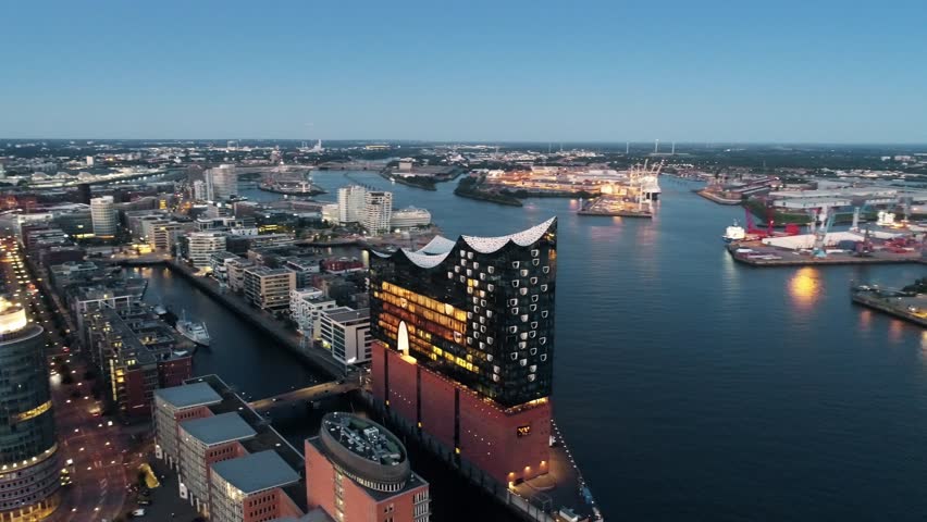 Aerial View of Elbphilharmonie and HafenCity at sunset, Hamburg, Hanseatic City. City lit up at night, Hamburg, Germany Night city landscape. Amazing architecture. Royalty-Free Stock Footage #1014175943