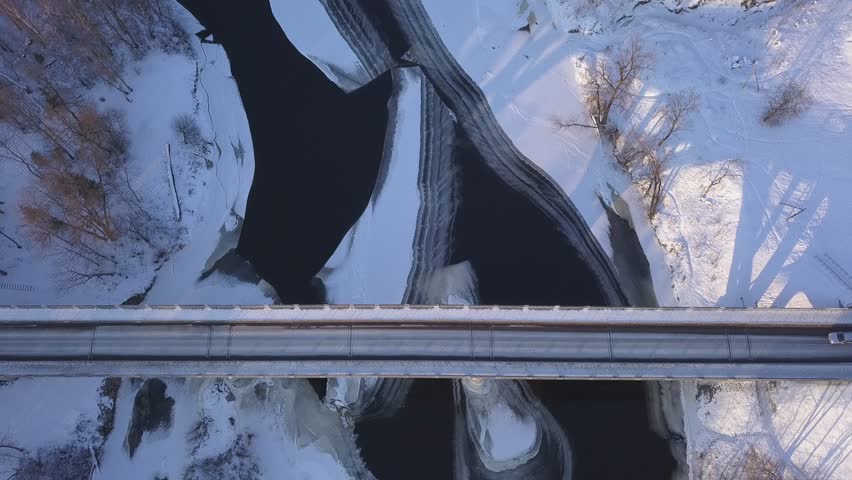 Bridge Winter Sigulda ice frozen river Gauja Latvia aerial drone top view 4K UHD video
