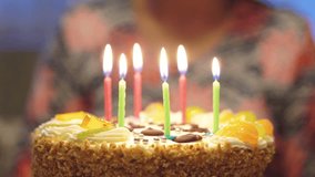Professional video of birthday candles on the cake being blown out in 4k slow motion 60fps