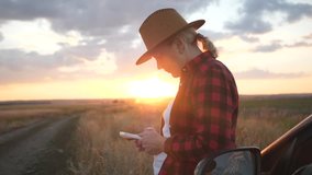 Girl agronomist with a smartphone analyzes the development of crops.