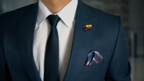 Businessman Walking Towards Camera With Country Flag Pin - Ecuador