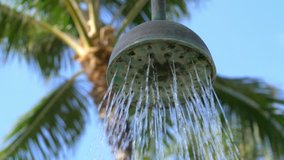 Professional video of taking a shower in jungle in 4k slow motion 60fps