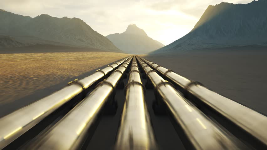 03579 Five streams of pipeline running through a desert with mouintains in background.