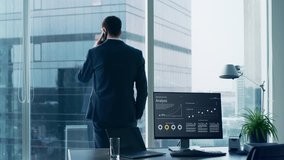 Confident Businessman in a Suit Standing in His Office, Looking out of the Window and Making Important Phone Call so He can Close the Deal.  - Powered by Shutterstock - Get 15% off with code: PIKWIZARD15