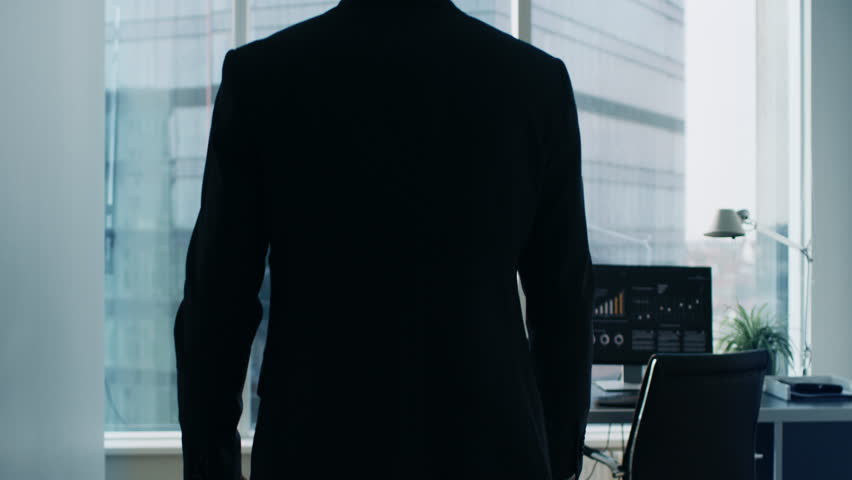 Following Shot of the Confident Businessman in a Suit Walking Through His Office and Looking out of the Window Thoughtfully.  Royalty-Free Stock Footage #1014231719