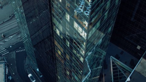 Aerial View Footage: From Outside into Office Building with Businessman Working and Looking out of the Window. Shot on RED EPIC-W 8K Helium Cinema Camera.