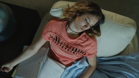 Crane shot zoom out of teenage girl sleeping while doing homework / Cedar Hills, Utah, United States