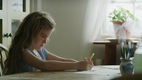 Slow motion of mother arriving at table helping daughter with homework / Pleasant Grove, Utah, United States