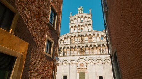 POV shot towards the San Michele in Foro Church in the medieval town of Lucca, Tuscany, Italy. Lucca is famous for its intact city walls dating from the Renaissance era