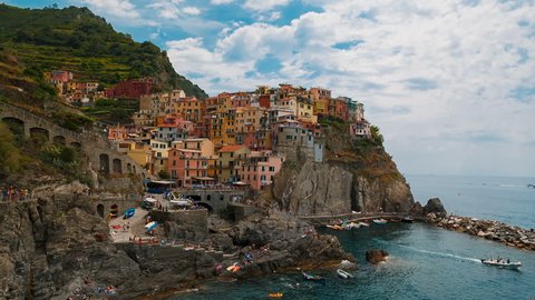Wide angle shot revealing the village of Manarola in Cinque Terre, Liguria, Italy, a UNESCO World Heritage Site, famous for its coastline, five villages and surrounding hillsides
