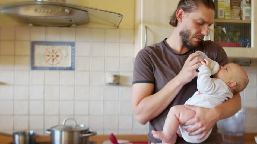 Baby food. A man is feeding a child from a bottle. Healthy eating, baby care for up to a year. Single father. Father's Day Royalty-Free Stock Footage #1014243782