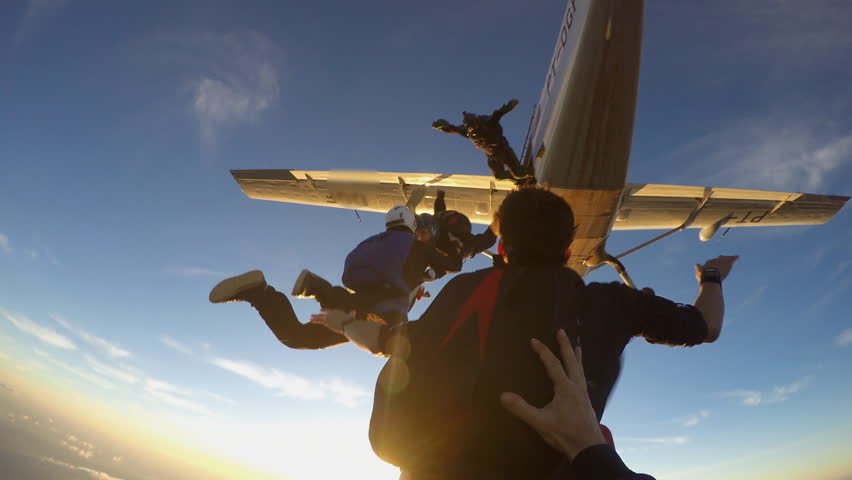Skydivers having fun at the amazing sunset 4K video Royalty-Free Stock Footage #1014253505