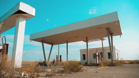 Old dirty deserted gas lifestyle station. U.S. Route 66. crisis road 66 fueling slow motion video. closed supermarket store shop Abandoned gas station oil end of fuel the world apocalypse petrol. main