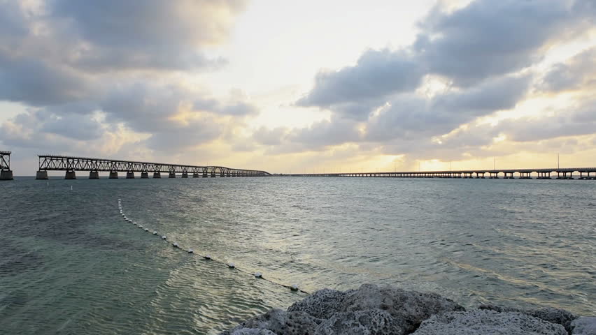 Sunset dark evening clouds in Bahia Honda State Park, Florida Keys, with old railroad bridges, ocean and gulf of mexico, slow motion