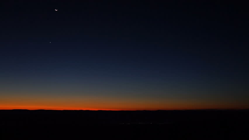 Morning dark sunrise with blue sky and flickering city lights in Dolly Sods, Bear Rocks, West Virginia with overlook of mountain valley, stars, moon, and Jupiter, Venus, Mars planets