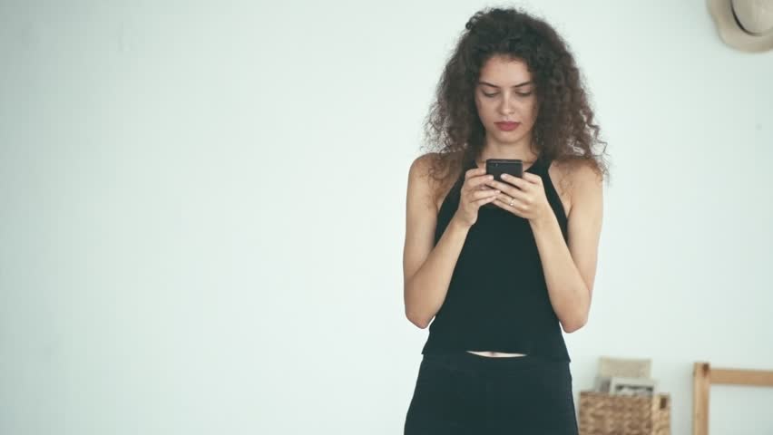 Girl with smartphone with funny expression, shallow depth of field