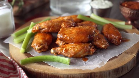Parallax slider footage of delicious chicken wings with sauce and blue cheese dip.
