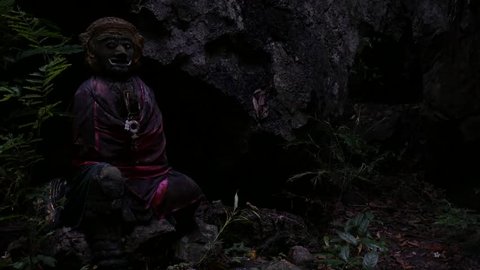 Scary and frightening statue in middle of the jungle in a dark and gloomy atmosphere, forest spirit in Thailand