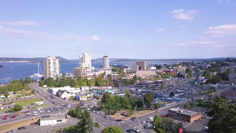 Downtown Nanaimo, British Columbia, Canada on Vancouver Island Filmed With 4k Aerial Drone of Downtown Core and Cityscape During Sunny Day. Camera Lifts and Tilts Revealing Buildings and Water