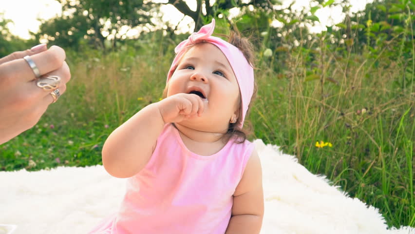Mother feeds her little daughter with yogurt | Shutterstock HD Video #1014276140
