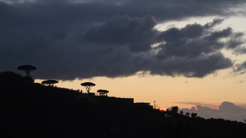 Amalfi coast, Italy, sunset in Sorrento. Sea waves, rocks and sun light. Mediterranean sea.
