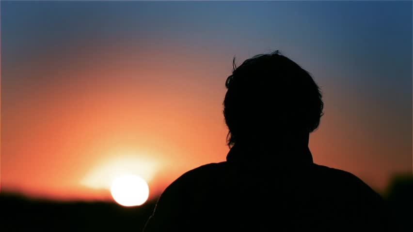 Silhouette of a Jet Pilot putting on Helmet at Dawn. Getting Ready to the Mission. 