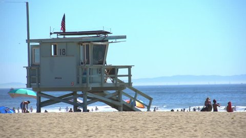 Venice Beach, California / USA - September 9th, 2016: Lifeguard Tower with Tourists and Locals at Venice Beach With Ocean Waves Surf.