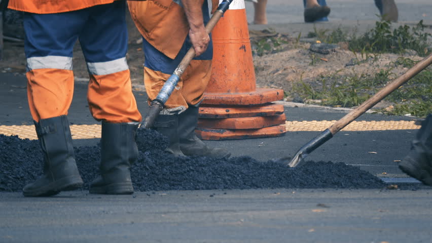 Road workers lay asphalt. Roadworks.  Royalty-Free Stock Footage #1014289805