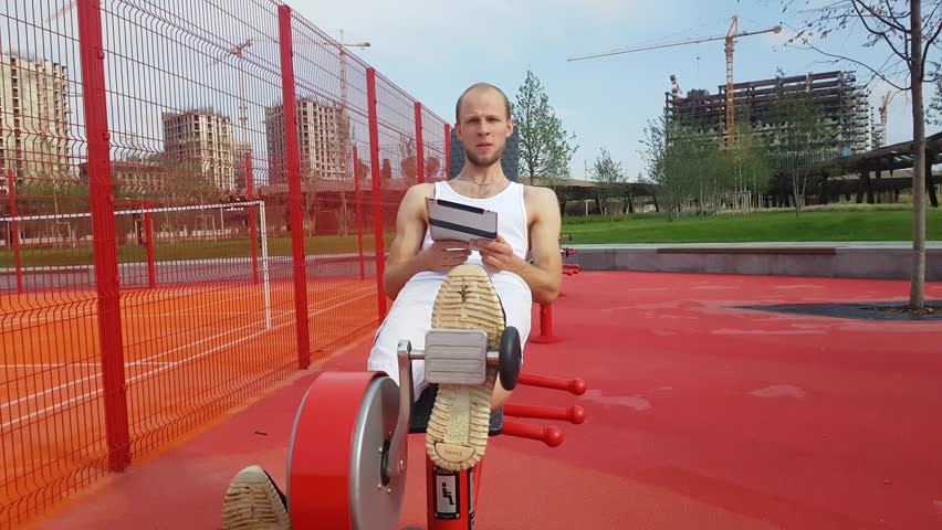 Man with tablet computer on workout