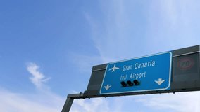 airplane flying over gran canaria airport signboard