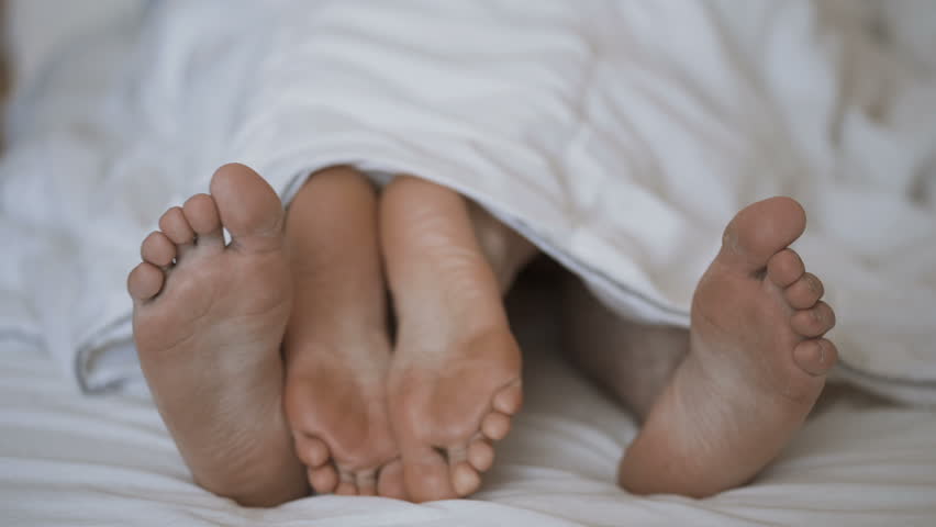 Couples feet. Alpha couple feet. Two boys lying in Bed barefeet with Computer. Alpha couple feet twitter. Two Mattresses put together.