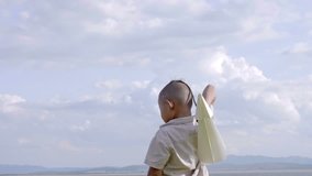 Asian boy with brain surgery and recovered from the wound, illness. Return to normal life. Playing with a paper airplane. Health care treatment and Life Insurance concept. 4K Video Slow motion