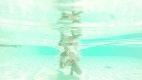 girl swimming underwater while diving