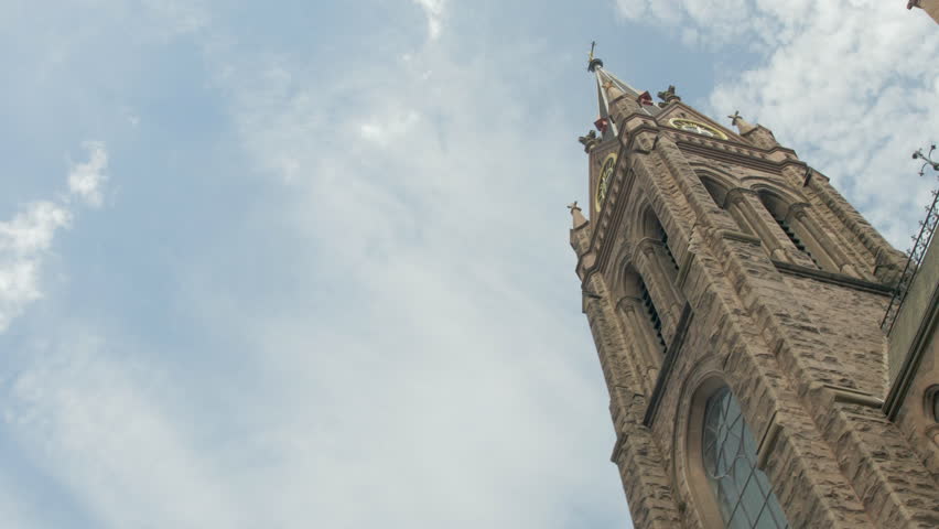 Large Cathedral Exterior, Low-angle, Looking up at a Nice Blue Sky and Rotating in Slow Motion