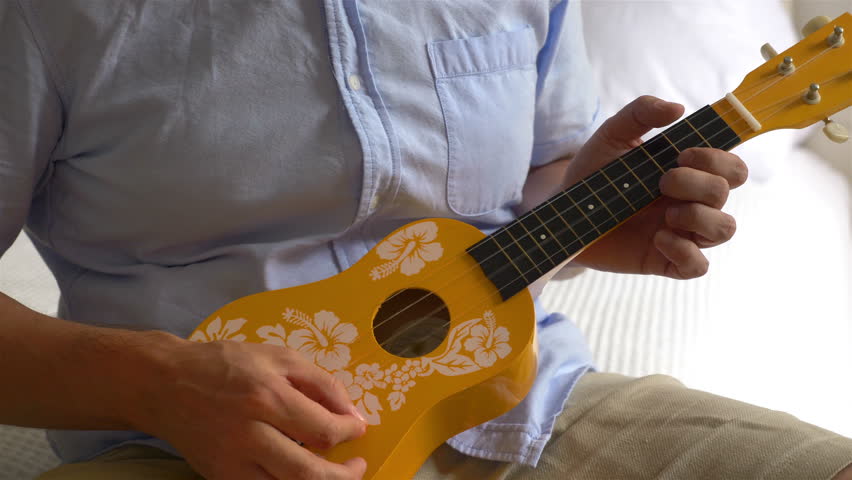 Professional video of young musican playing ukulele
