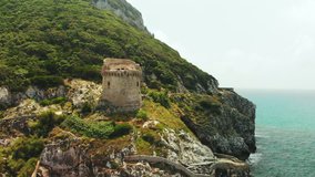 Tower of Paola. It's construction of the Middle Ages times. Sabaudia, Lazio, Italy. Riviera di Ulysses. Aerial drone view to big mountain and turquoise sea water