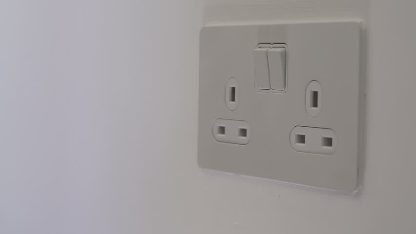 Man inserts plug into socket with adapter | Shutterstock HD Video #1014354455