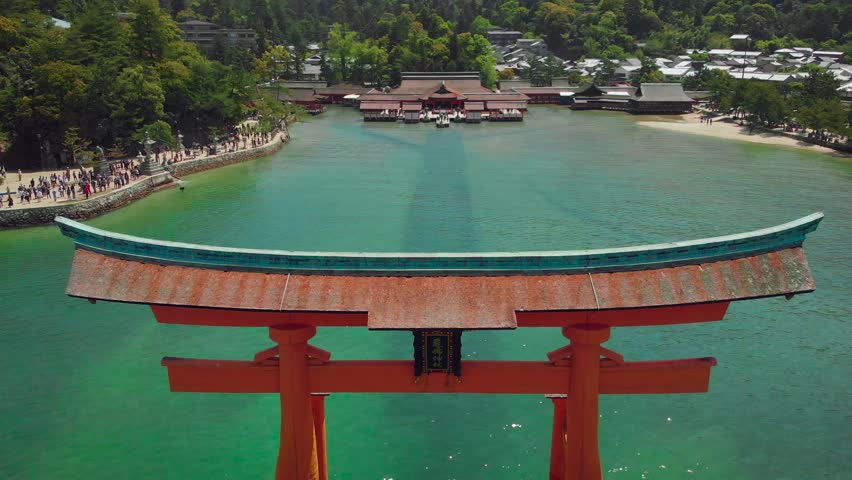 Aerial Drone dramatically flying away from Itsukushima Shrine at Miyajima, Hiroshima, Japan Royalty-Free Stock Footage #1014354590