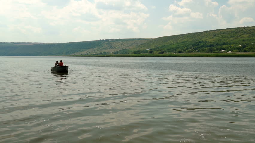Two people on a boat floating on the river
