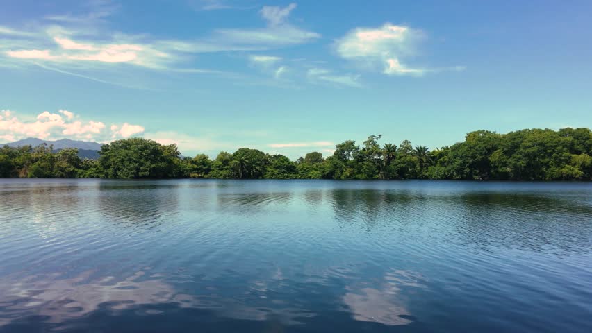View of a placid lake located in Tela, Honduras shot on a sunny day in the afternoon.
