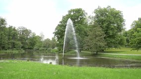 Slow motion of fountain in center of lake at park