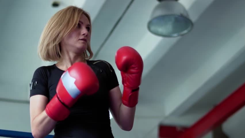 Traainer using noodle to work out the precisions of blows, man training woman