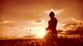 woman praying on her knees. Girl folded her hands in prayer silhouette at sunset. slow motion video lifestyle. Girl folded her hands in prayer pray to God. the girl praying asks forgiveness for sins